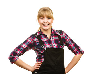 Smiling standing woman wearing dungarees and shirt