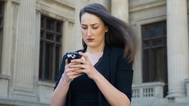 Office woman feeling empowered and optimistic after sending message on smartphone