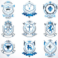 Heraldic vector signs decorated with vintage elements, monarch crowns, religious crosses, armory and animals. Set of classy symbolic graphic insignias.