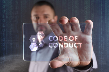 Business, Technology, Internet and network concept. Young businessman working on a virtual screen of the future and sees the inscription: Code of conduct