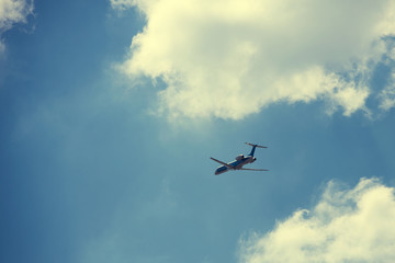 plane flies in the blue sky