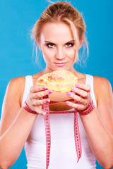 Woman holds sweet bun recommending non sugar diet