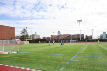 Students playing soccer on the field. team athletes training. blurred background due to the concept. empty space for your text