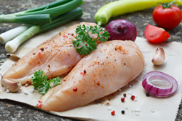 Raw chicken breast with herbs and vegetables - ready for cooking