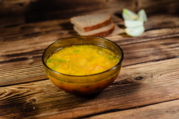 Vegetable soup in a glass bowl on wooden table