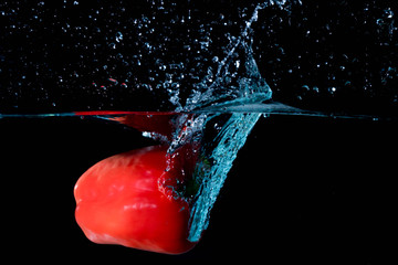 Red Bell Sweet Pepper Droped Into Water