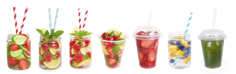 Drinks from strawberries, blueberries, orange, cucumber. Collage of lemonades isolated on white background. Set of different refreshing drink with striped straw. Drinks in a glass jar.