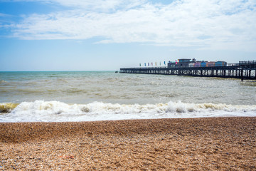 Stony beach front in Hastings and a new pier in a distance