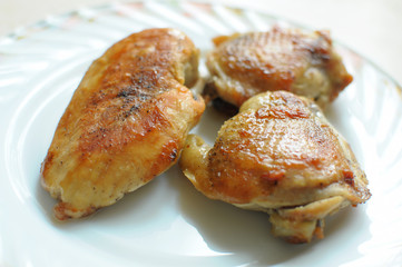 Baked chicken thighs and breast close up
