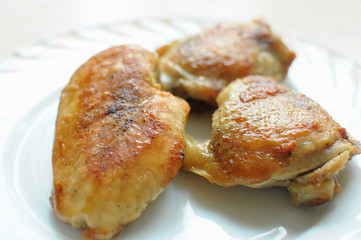 Baked chicken thighs and breast close up