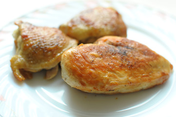 Baked chicken thighs and breast close up