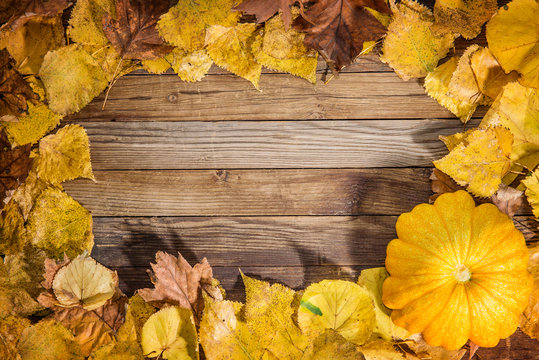 beautiful wooden background with autumn leaves