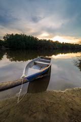 an abandoned old boat at Kg Pulau Kerengga, Marang, Malaysia with sunset scenery