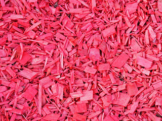 Bark wood chips background. Pink color pieces of wooden splinters. Painted pieces of tree for decoration and design, backcloth