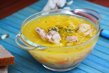 Soup with chicken meat on a blue background