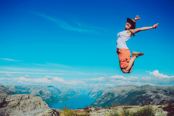 The happy tourist is jumping. Norway. Background.