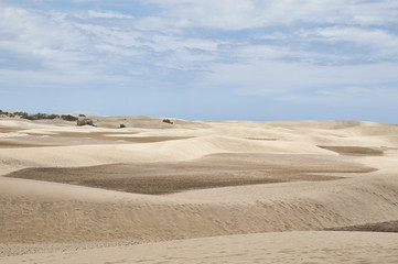 View towards the unusual sand formations, the Maspalomas Dunes, a popular landmark and tourist attraction, in Gran Canaria, Spain