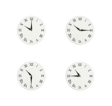Closeup group of white clock with shadow for decorate show the time in 10 , 10:15 , 10:30 , 10:45 a.m. isolated on white background , beautiful 4 wall clock picture in different time