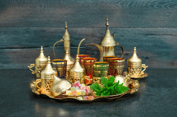 Fototapeta na wymiar Oriental tea coffee table golden dishes delight mint Ramadan