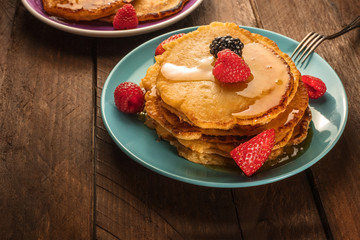 Homemade pancakes with fresh fruit and honey