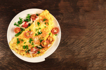 Omelette with parsley, cherry tomatoes, and copyspace