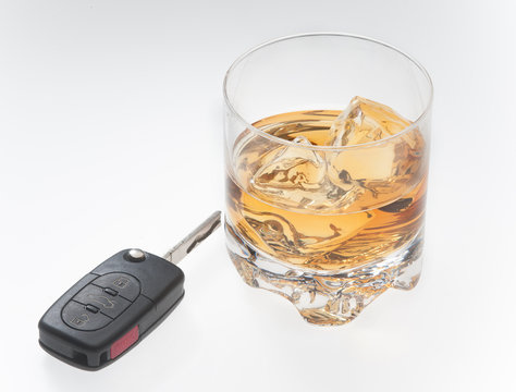 Drinking and driving concept with whiskey and car keys