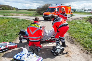 Rettungsdienst und Notarzt versorgen schwer kranken Mann an einer Einsatzstelle