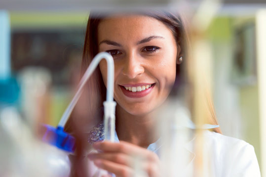 Woman scientist carrying out experiment in research laboratory