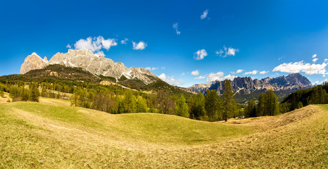 summer landscape panorama mountains. Dolomites Italy. blu sky and green grass