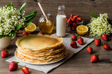 Delicious pancakes on wooden table with fruits