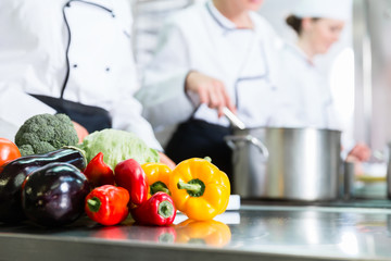 chefs preparing meals in commercial kitchen