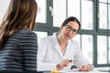 Female physician listening to her patient during consultation in the office of a medical center
