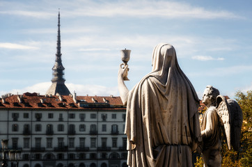 Church of the Gran Madre di Dio in Turin (Piedmont, Italy), detail of the "Faith" sculpture holding a chalice toward the Mole Antonelliana, symbol of the city