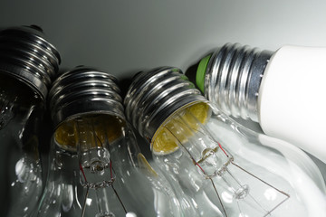 Glowing led lamp and incandescent bulbs in the dark