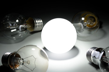 Glowing led lamp and incandescent bulbs in the dark
