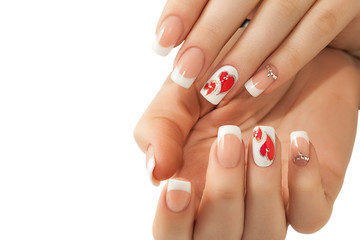 Manicure. White nails with red hearts. Isolated.