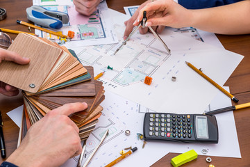 Architects discuss which team to choose the color of the house. house design with working tools.