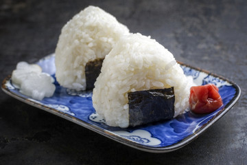 Traditional Japanese Onigiri with Umeboshi as close-up on a bowl
