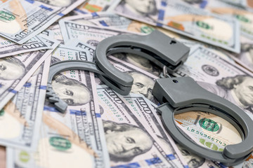 handcuff above usa dollar. close up .