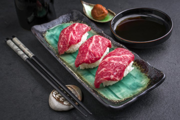 Traditional Japanese Wagyu Nigiri Sushi with Umiboshi as close-up on a bowl
