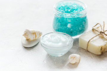 Fototapeta na wymiar Home cosmetic with cream and blue sea salt on white background
