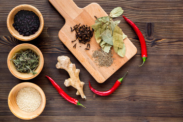 Spices, chili and herbs on wooden kitchen table background top view mock up