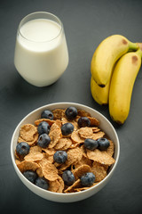Healthy food. Milk, multi grain flakes with blueberry for breakfast.