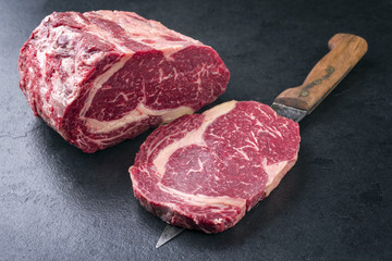 Raw dry aged Kobe Entrecote Steak as close-up on a slate .