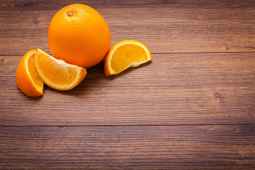 orange on a wooden surface. arrangement of sliced fruit.