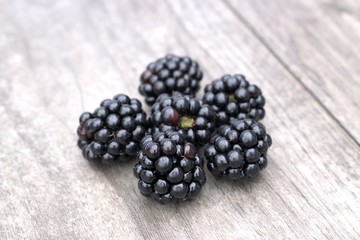Fresh blackberries on a wooden background.