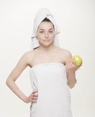 Girl holds a green apple and smiles