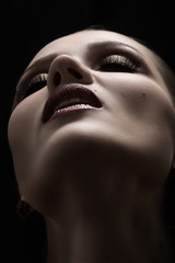 luxury beautiful female face with professional makeup on black background