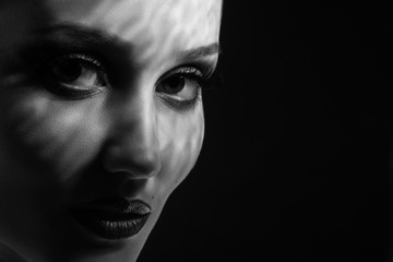 happy luxury woman model with professional makeup on black background, monochrome © tugolukof