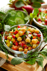 Fresh vegetarian salad with chickpeas, chopped peppers, onions, cucumbers, carrots and herbs. Healthy and nutrition diet